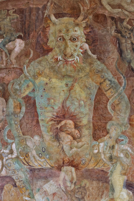 Pisa, Camposanto monumentale:
“Inferno”; particolare con “Lucifero", figura gigantesca, di dimensioni doppie rispetto al Cristo giudice. Lucifero rappresenta l'orgoglio, radice di tutti i vizi. Il dannato divorato da Lucifero è Giuda Iscariota, maciullato nella bocca centrale del mostro. Lucifero divora anche Bruto e Cassio nelle bocche laterali. Giuda è considerato il traditore supremo per aver tradito Cristo, mentre Bruto e Cassio tradirono Giulio Cesare, considerato un benefattore e simbolo dell'Impero.
Affreschi di Buonamico Bufalmacco, 1336/1341.

[ENG]
Pisa, Monumental Cemetery: “Hell”; detail with “Lucifer,” a gigantic figure twice the size of Christ the Judge. Lucifer represents pride, the root of all vice. The damned soul devoured by Lucifer is Judas Iscariot, mangled in the monster’s central mouth. Lucifer also devours Brutus and Cassius in the lateral mouths. Judas is considered the supreme traitor for betraying Christ, while Brutus and Cassius betrayed Julius Caesar, c...