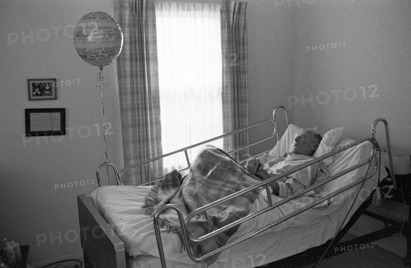 Elderly Man in Hospital Bed