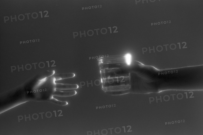 Hands Passing Glass of Water