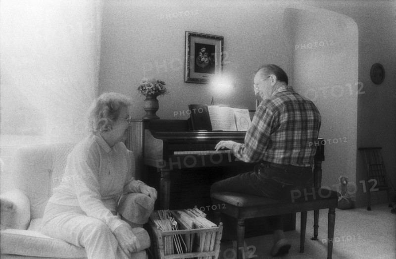 Elderly Couple Singing and Playing Piano