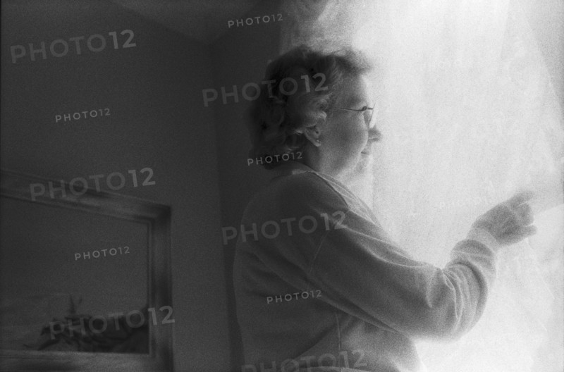 Elderly Woman Looking Out Window