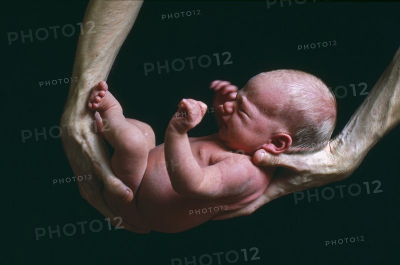 Father Holding Newborn Baby