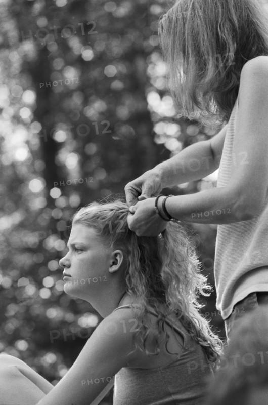 Mother Braiding Daughter's Hair