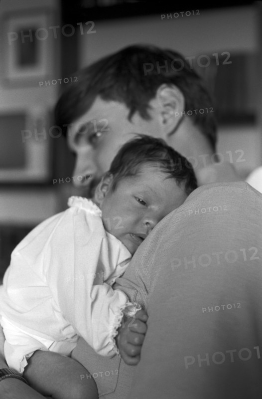 Father Holding Newborn Baby