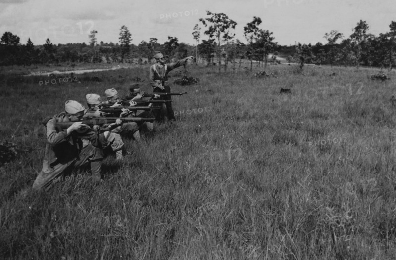 Group of Soldiers Displaying Proper Shooting Position in Field During Training Session, WWII, 2nd Battalion, 389th Infantry, US Army Military Base Indiana, USA, 1942