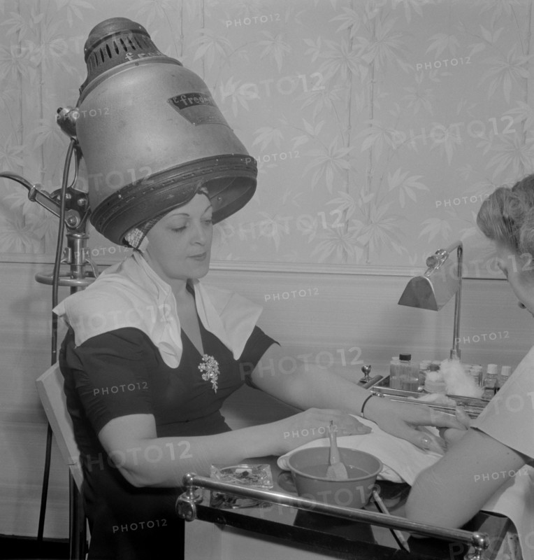 Woman Getting Manicure while Drying Hair at Hair Salon, Eighth Street, New York City, New York, USA, Marjorie Collins for Office of War Information, September 1942