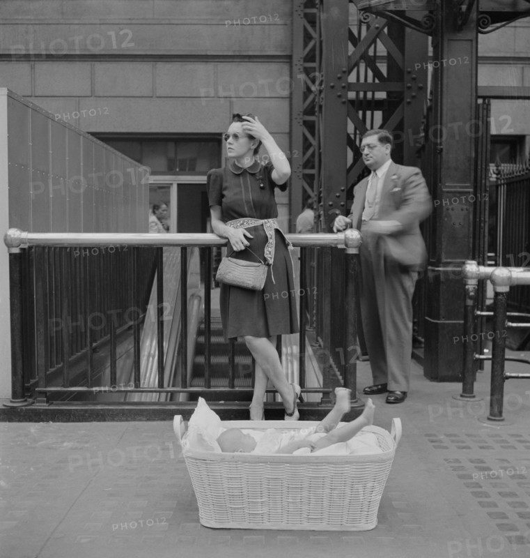 Woman with Baby in Basket Waiting for Train, Pennsylvania Station, New York City, New York, USA, Marjorie Collins for Office of War Information, August 1942