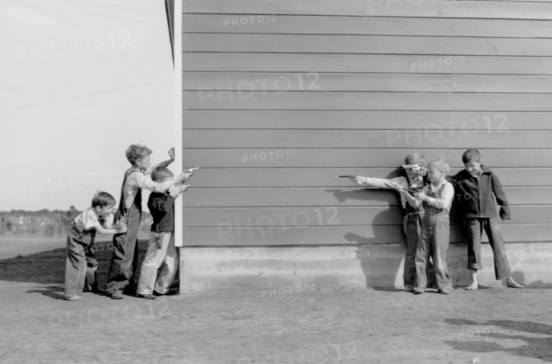 School Children Playing with Toy Guns, Farm Security Administration (FSA) Camp, Weslaco, Texas, USA, Arthur Rothstein for Farm Security Administration (FSA), January 1942