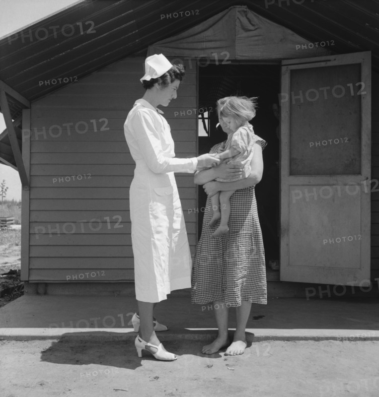 Resident Nurse Visiting a Sick Child, Farm Security Administration (FSA) Camp, Farmersville, Tulare County, California, USA, Dorothea Lange for Farm Security Administration, May 1939