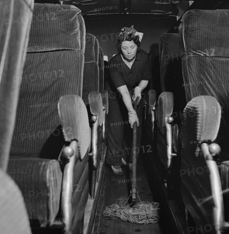 Charwoman Mopping Floor of Bus at Greyhound Garage, Pittsburgh, Pennsylvania, Esther Bubley for Office of War Information, September 1943