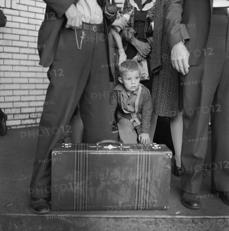 Young Boy with Group of People Waiting for Greyhound Bus during Trip from Louisville, Kentucky to Memphis, Tennessee, USA, Esther Bubley for Office of War Information, September 1943