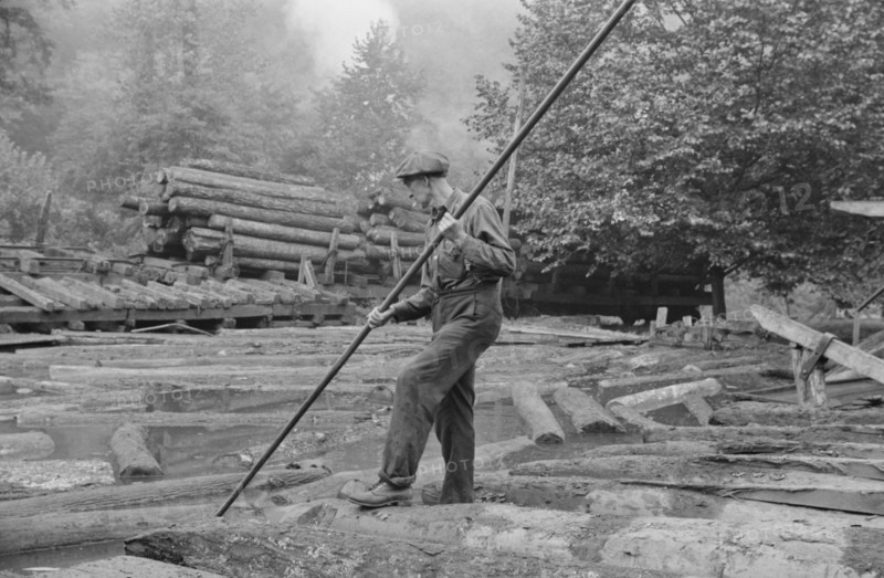 Man Spiking Logs to go up Ramp to Sawmill, Erwin, West Virginia, USA, Marion Post Wolcott for Farm Security Administration, September 1938