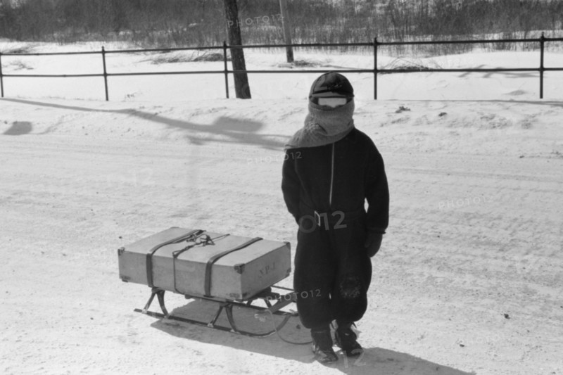 Child Bringing Home Suitcase on Sled, Franconia, New Hampshire, USA, Marion Post Wolcott for Farm Security Administration, March 1940