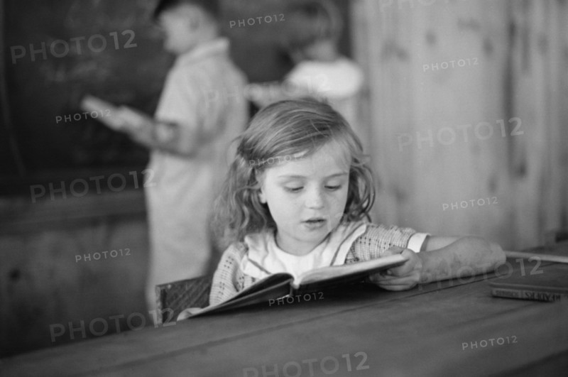 Young Girl Reading Book in Classroom, Cumberland Mountain Farms, near Scottsboro, Alabama, USA, Carl Mydans for U.S. Resettlement Administration, June 1936
