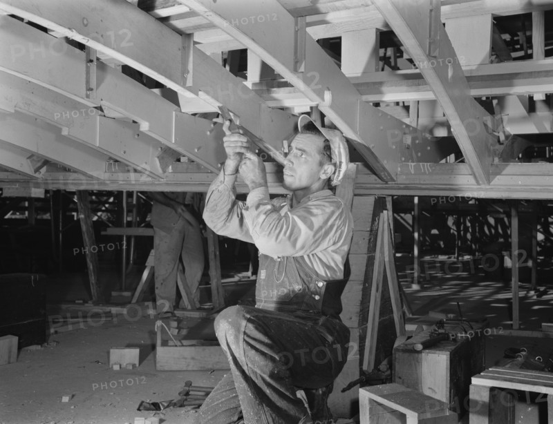 Carpenter Building Torpedo Boats at Shipyard during WWII, New Orleans, Louisiana, USA, Howard R. Hollem for Office of War Information, July 1942