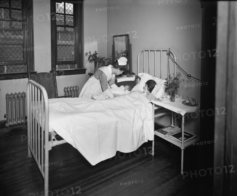 Nurse Bringing Newborn Infant to Mother in Hospital Room, Garfield Hospital, Washington, DC, USA, National Photo Company, 1921