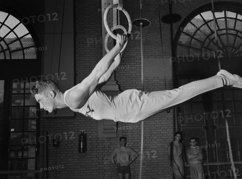 Gymnast on Still Rings, U.S. Naval Academy, Annapolis, Maryland, USA, by Lieutenant Whitman for Office of War Information, July 1942