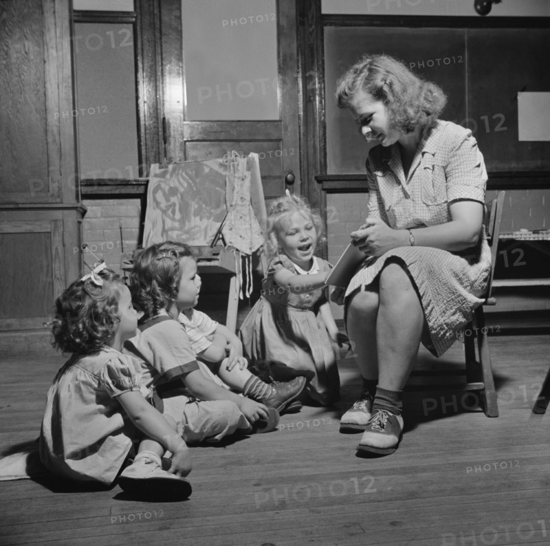 Woman Reading Story to Three Young Children at Child Care Center, New Britain, Connecticut, USA, Gordon Parks for Office of War Information, June 1943
