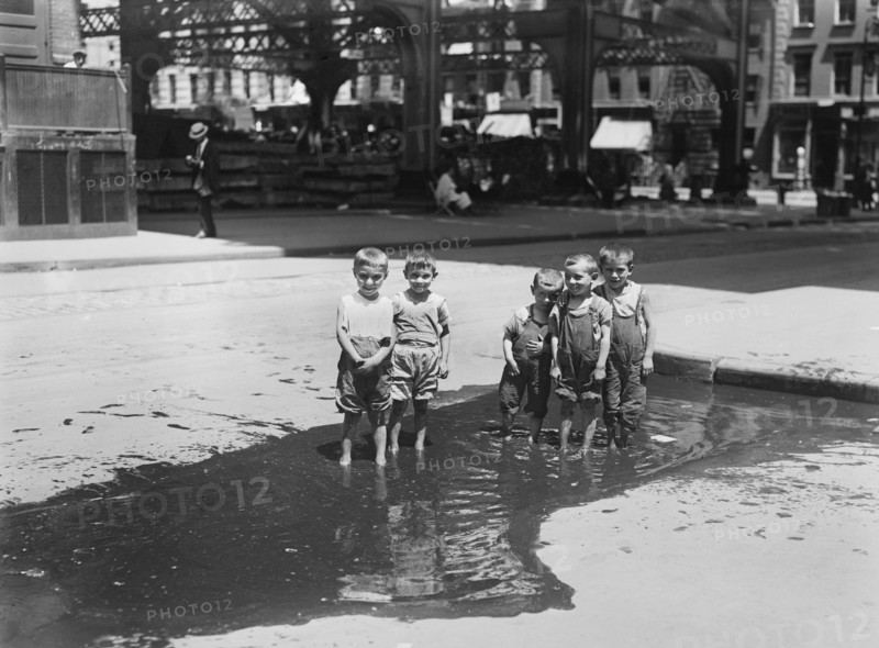 Group of Small Boys Standing in Street Puddle, New York City, New York, USA, Bain News Service, July 1913
