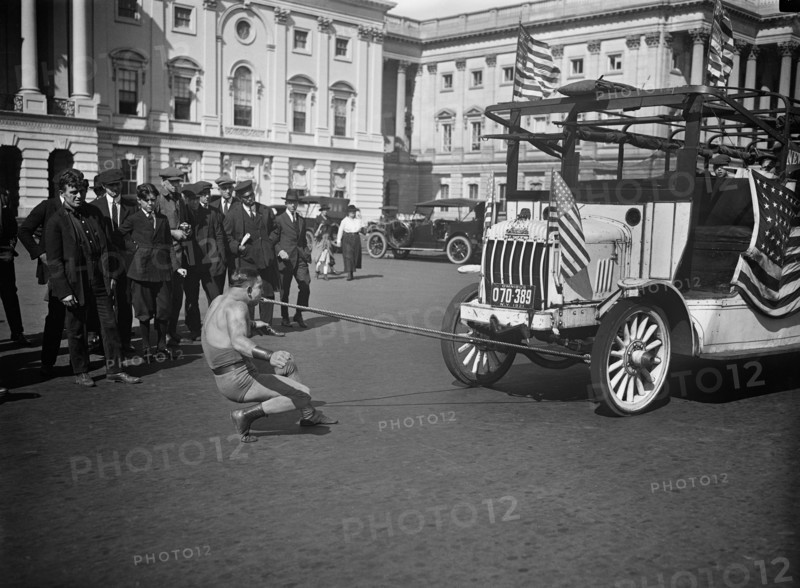 Man Pulling Bus with Teeth outside U.S. Capitol Building, Washington DC, USA, Harris & Ewing, 1921