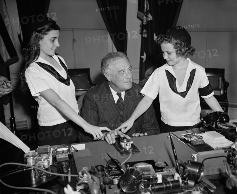 U.S. President Franklin Roosevelt with Two Camp Fire Girls Pressing Telegraph Key to Light Crossed Logs and Flame Lamp in Organization's New National Headquarters in New York City, Washington DC, USA, Harris & Ewing, March 1939