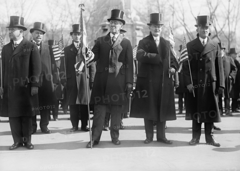 President Woodrow Wilson (center), Vice President Thomas Marshall to Wilson's left, Holding American Flags during Parade Honoring Wilson's Return from Paris Peace Conference, Washington DC, USA, Harris & Ewing, March 1919