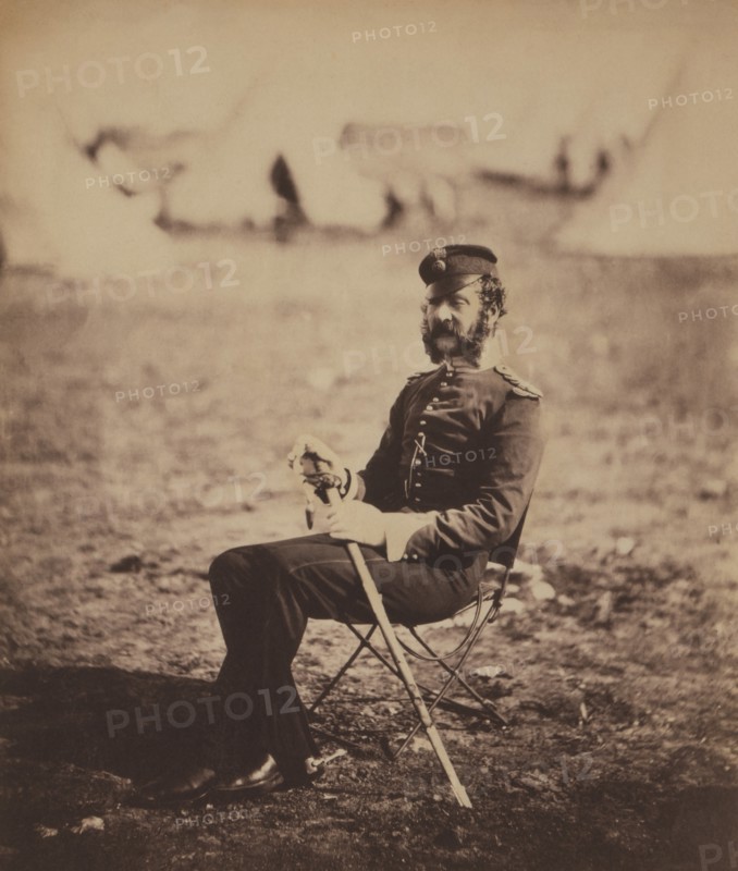 British Major Percy Archer Butler, Seated Portrait in Uniform and Holding Sword with Military Tents in Background, Crimean War, Crimea, Ukraine, by Roger Fenton, 1855