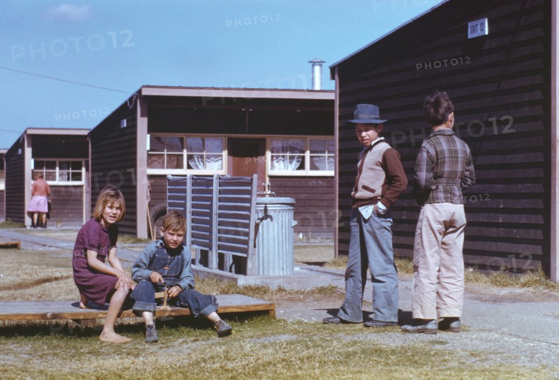 Boy Building Model Airplane while other Children Look on, Farm Security Administration (FSA) Labor Camp, Robstown, Texas, USA, Arthur Rothstein for Farm Security Administration - Office of War Information, January 1942