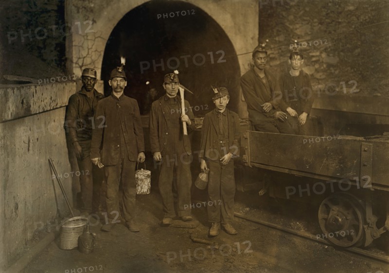 Coal Miners with Young Trapper Boy in Center, Full-Length Portrait at Mine Entrance, Gary, West Virginia, USA, Lewis Hine for National Child Labor Committee, September 1908