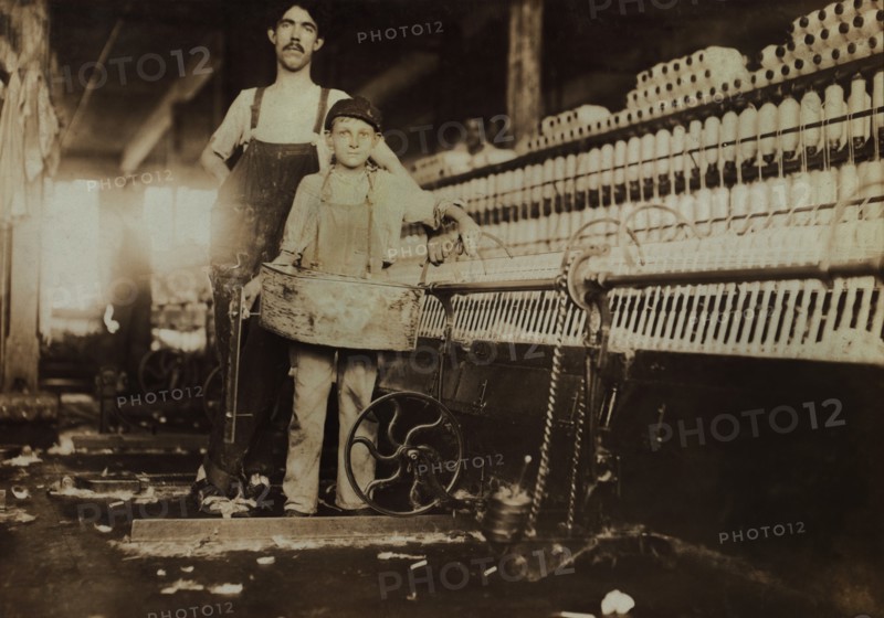 Young "Tube Boy" with Injured Finger and Overseer in Mule Room, Richmond Spinning Mill, East Lake, Chattanooga, Tennessee, USA, Lewis Hine for National Child Labor Committee, December 1910