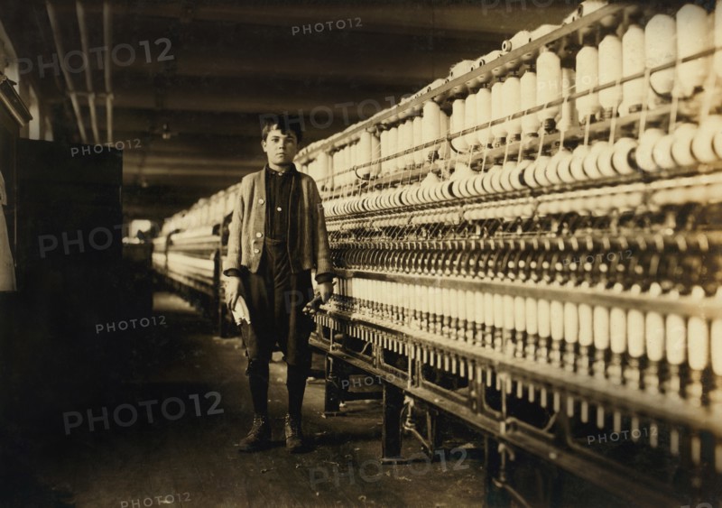 Andrew Stefanik, Young Bobbin Boy, Full-Length Portrait with Spinning Machinery, Textile Mill, Chicopee, Massachusetts, USA, Lewis Hine for National Child Labor Committee, November 1911