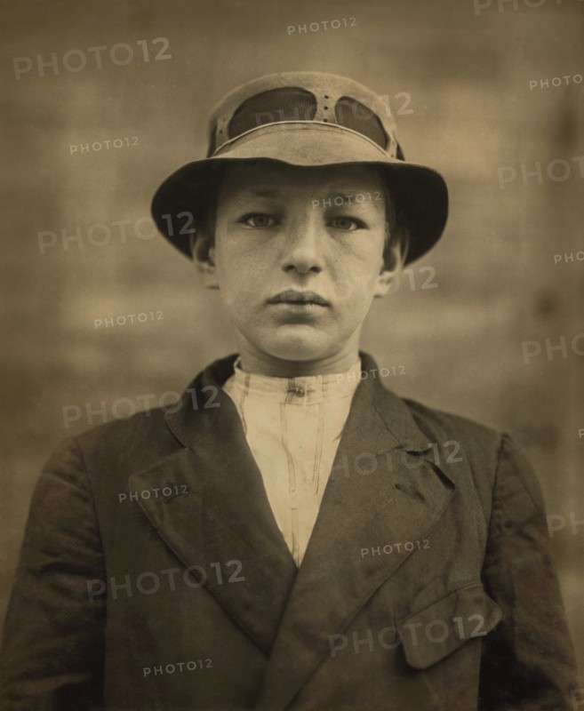 William Gross, 15-year-old Newsboy, has been selling Newspapers for 5 years, Average Earnings 50 cents per week, also Guides Men to Houses of Prostitution, Half-length Portrait, Wilmington, Delaware, USA, Lewis Hine for National Child Labor Committee, May 1910