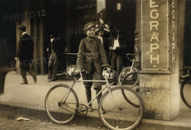 Postal Telegraph Messenger, Portrait Standing with Bicycle at Sidewalk, Birmingham, Alabama, USA, Lewis Hine for National Child Labor Committee, November 1910