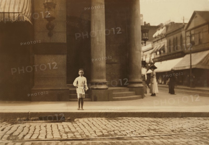Young Newsboy, Full-Length Portrait Standing in Bare Feet on Sidewalk, New Bedford, Massachusetts, USA, Lewis Hine for National Child Labor Committee, August 1911