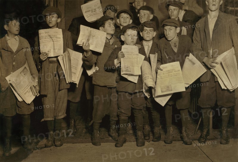 Group of Young Newsies, Full-Length Portrait Selling Newspapers on 12th Street after Midnight, Washington DC, USA, Lewis Hine for National Child Labor Committee, April 1912