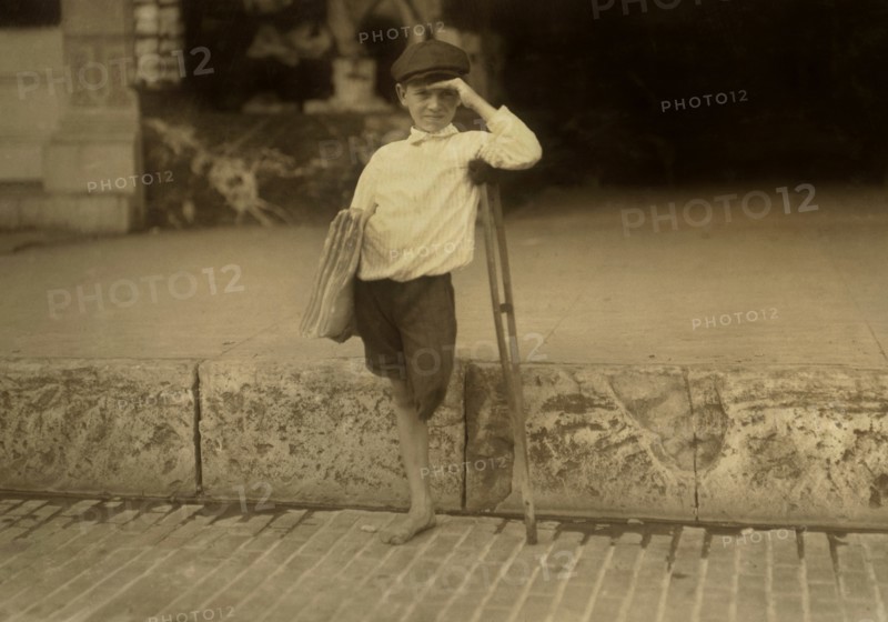 Albert Schafer, 8 years old, Newsboy, Amputee, Full-Length Portrait, Austin, Texas, USA, Lewis Hine for National Child Labor Committee, October 1913