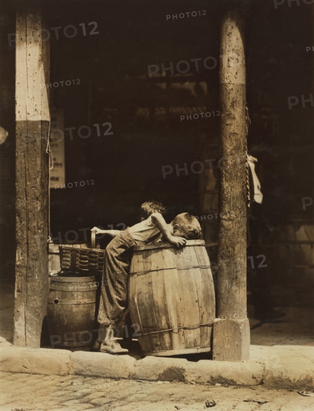 Two Young Brothers Picking Discarded Fruit out of Barrels near 14th Street, New York City, New York, USA, Lewis Hine for National Child Labor Committee, July 1910