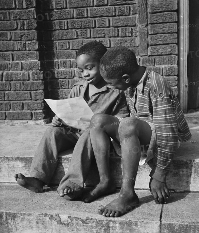 Two Young Boys Reading Instructions for Scrap Collection, Roanoke, Virginia, USA, Howard Liberman for Office of War Information, October 1942