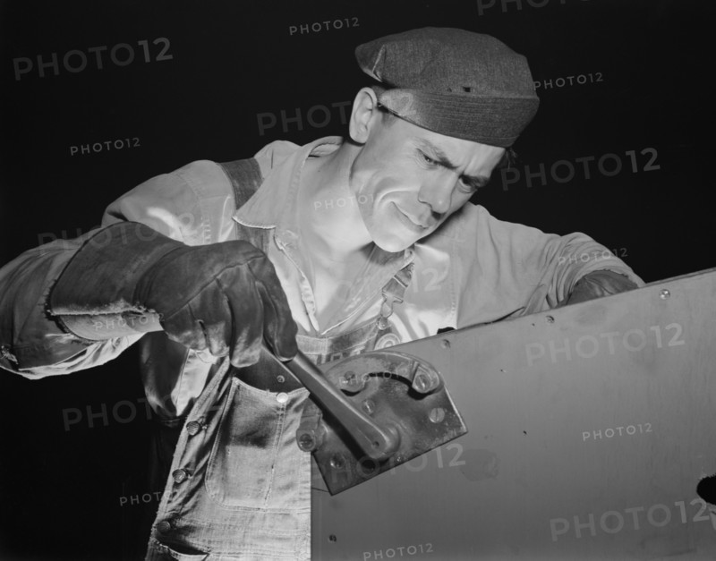 Worker working on Fifty-Foot Steel Ramp Boat, Higgins Industries, New Orleans, Louisiana, USA, Howard R. Hollem for Office of War Information, July 1942