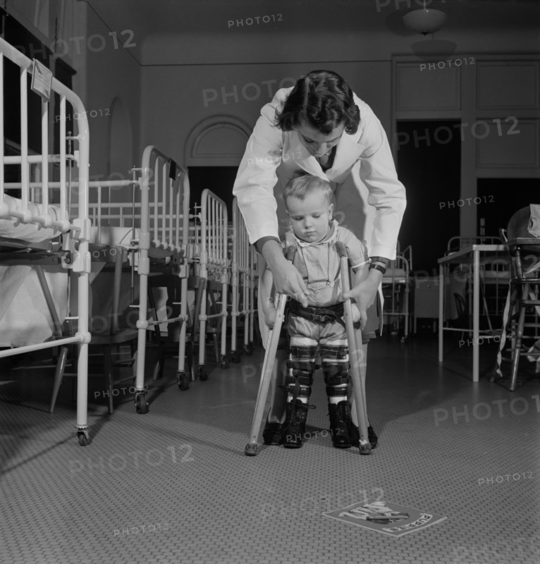A student Nurse, Acting as Physical Therapist, Points to the Picture Book, Encouraging a Child to Learn to use his Crutches, Fritz Henle for Office of War Information, November 1942