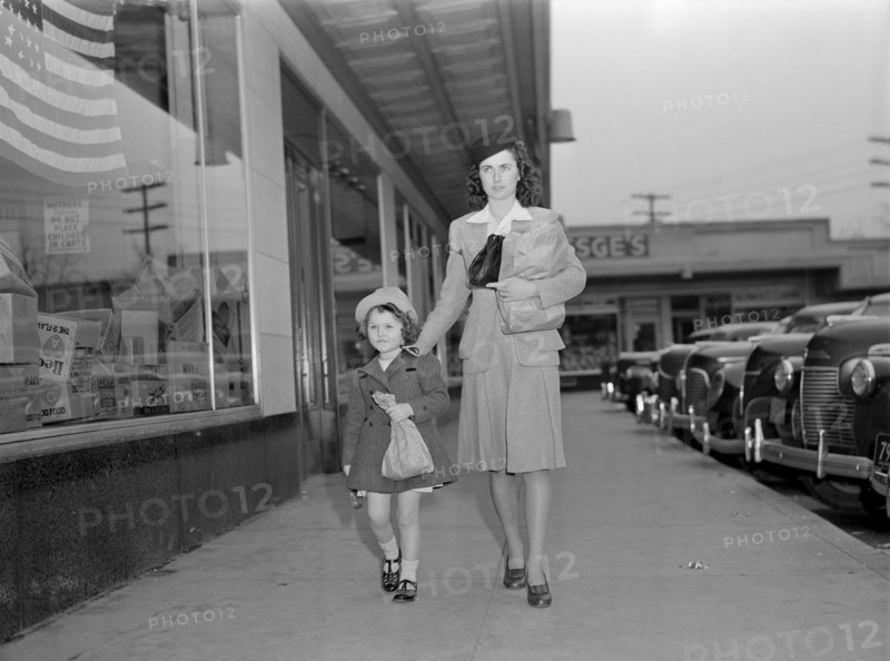 Mother and Daughter Walking Home with Bundles after Shopping While Helping to Conserve Tires on Car or a Merchant's Delivery Truck, as well, during War Effort, Ann Rosener, Office of War Information, February 1942