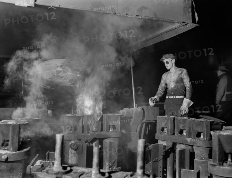 Operator of Electric Furnace Pouring Molten Metal into Molds, Chase Brass and Copper Company, Euclid, Ohio, USA, Alfred T. Palmer for office of War Information, February 1942