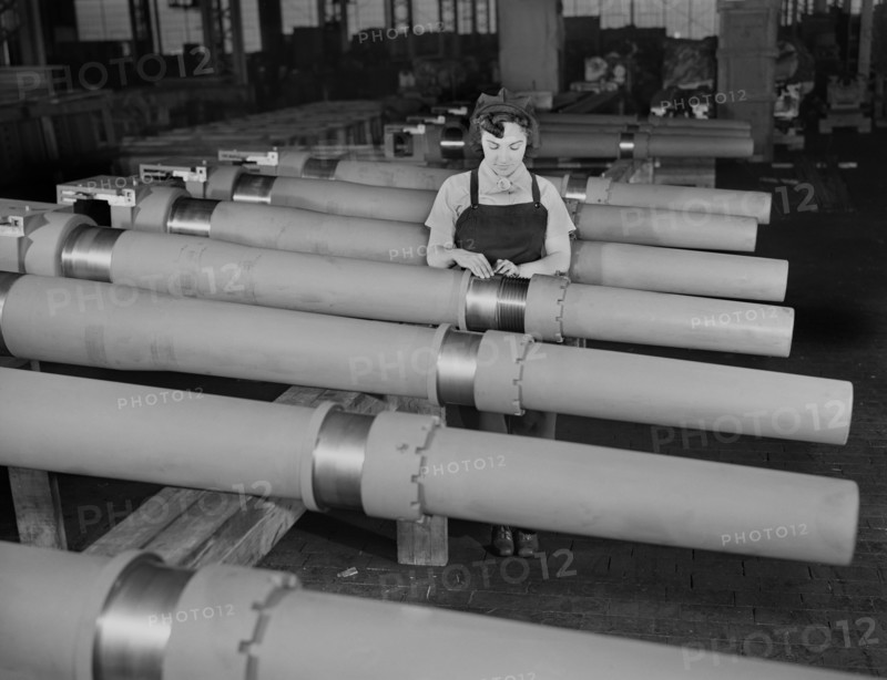 Mrs. Mary Betchner Inspecting 105mm Howitzer Artillery on Assembly Line, Chain Belt Company, Milwaukee, Wisconsin, USA, Howard R. Hollem for Office of War Information