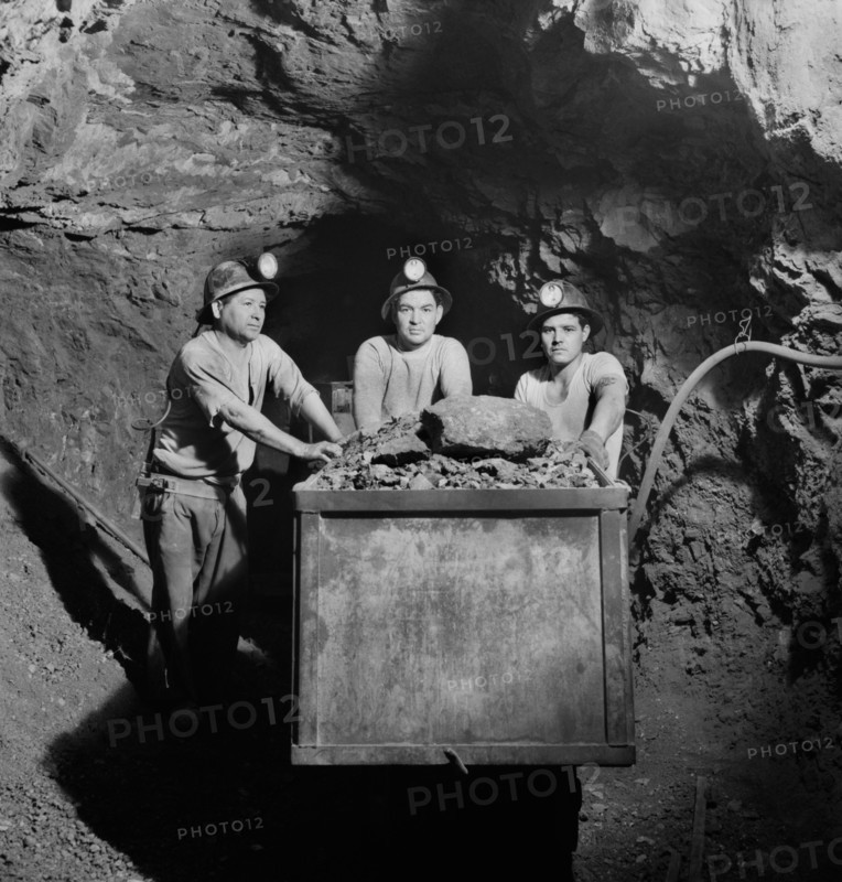 Three Miners Loading Mercury Ore into Mine Car by Hand, Quicksilver Mining Company, New Idria, California, USA, Andreas Feininger for Office of War Information, December 1942