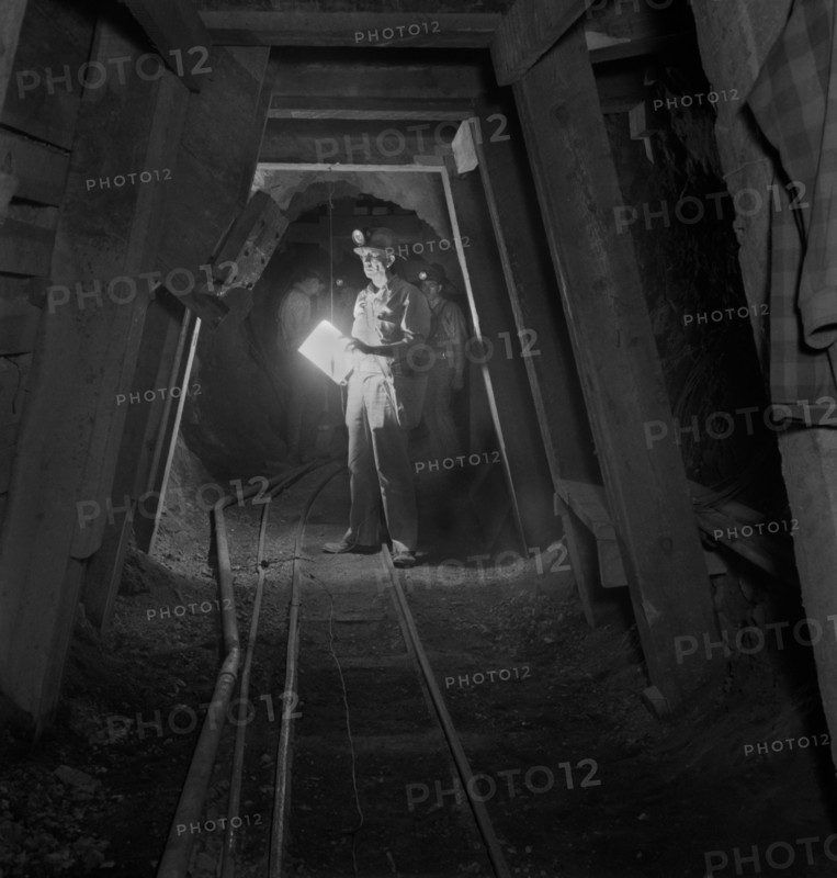 Worker Inspecting New Timbering in Mining Tunnel, Quicksilver Mining Company, New Idria, California, USA, Andreas Feininger for Office of War Information, December 1942