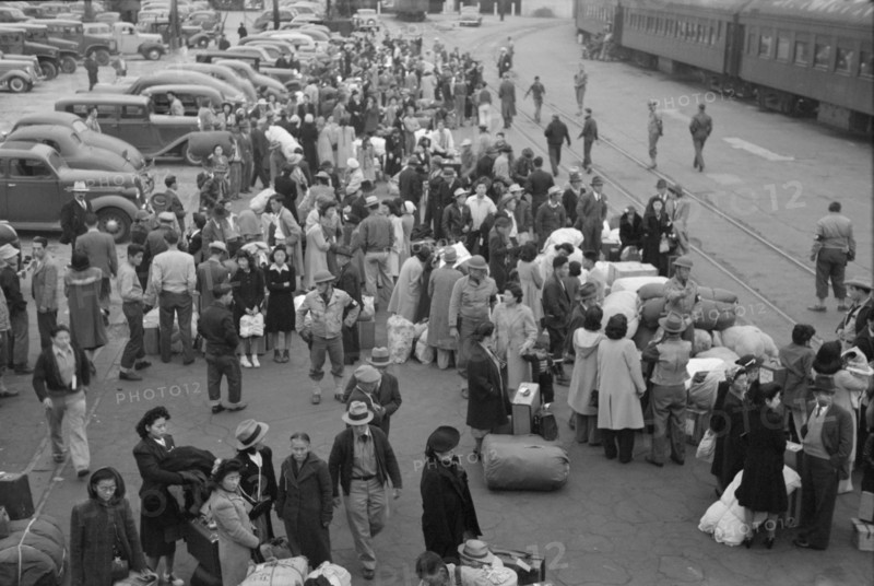 Japanese-Americans Waiting for Train to Owens Valley During Evacuation of Japanese-Americans from West Coast Areas under U.S. Army War Emergency Order, Los Angeles, California, USA, Russell Lee, Office of War Information, April 1942