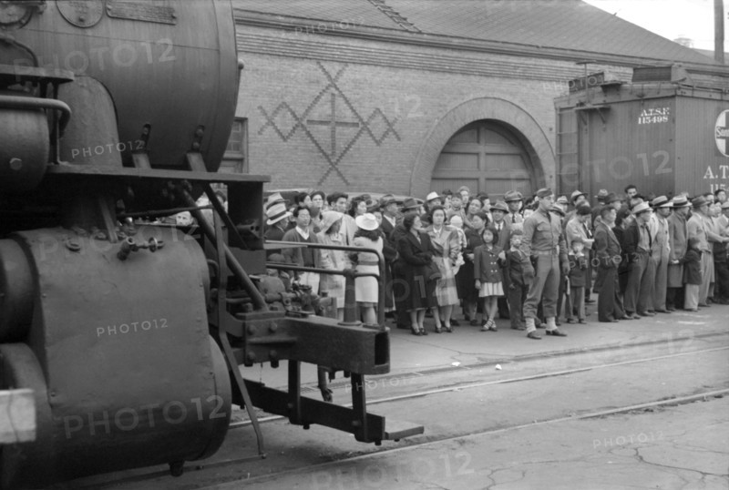 Japanese-Americans Waiting for Train to Owens Valley During Evacuation of Japanese-Americans from West Coast Areas under U.S. Army War Emergency Order, Los Angeles, California, USA, Russell Lee, Office of War Information, April 1942