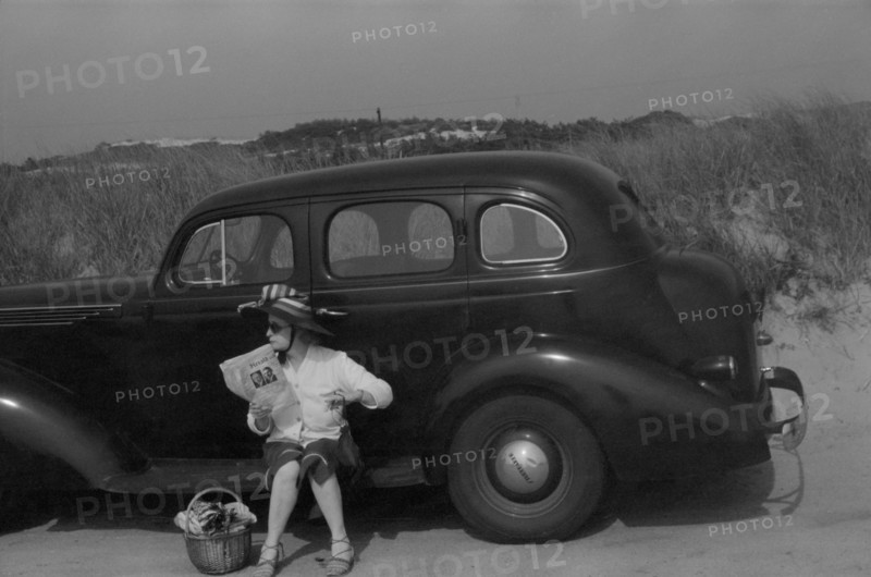 Woman Relaxing on Car at Beach, Provincetown, Massachusetts, USA, Edwin Rosskam, Farm Security Administration, August 1940