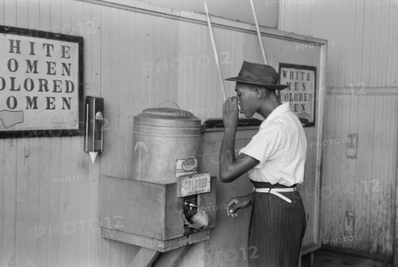 Man Drinking Water at "Colored" Water Cooler in Bus Terminal, Oklahoma City, Oklahoma, USA, Russell Lee, Farm Security Administration, July 1939