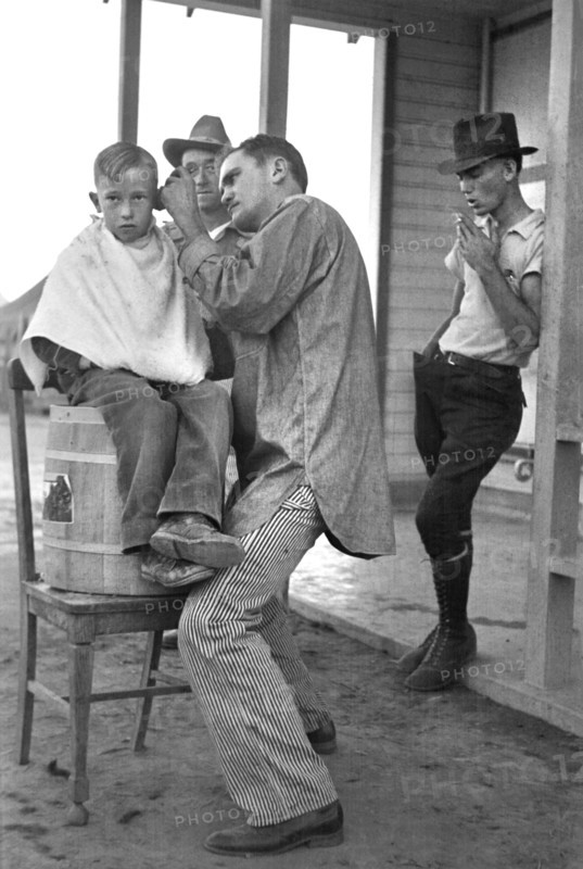 Boy Getting Haircut, Community Barber Shop, Migrant Camp, Kern County, California, USA, Dorothea Lange, Farm Security Administration, November 1936
